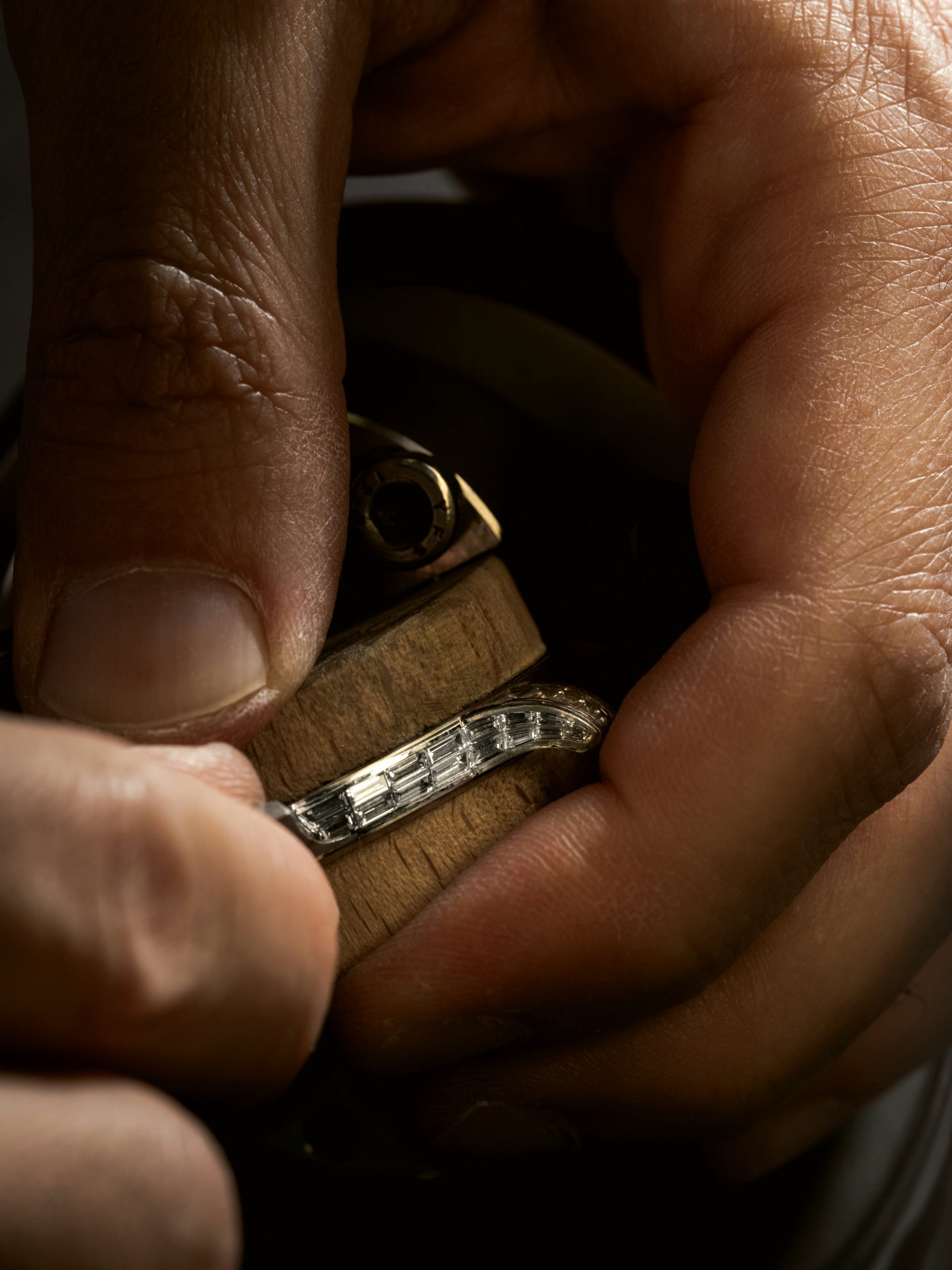 Baguette diamonds set by hand into a watch component