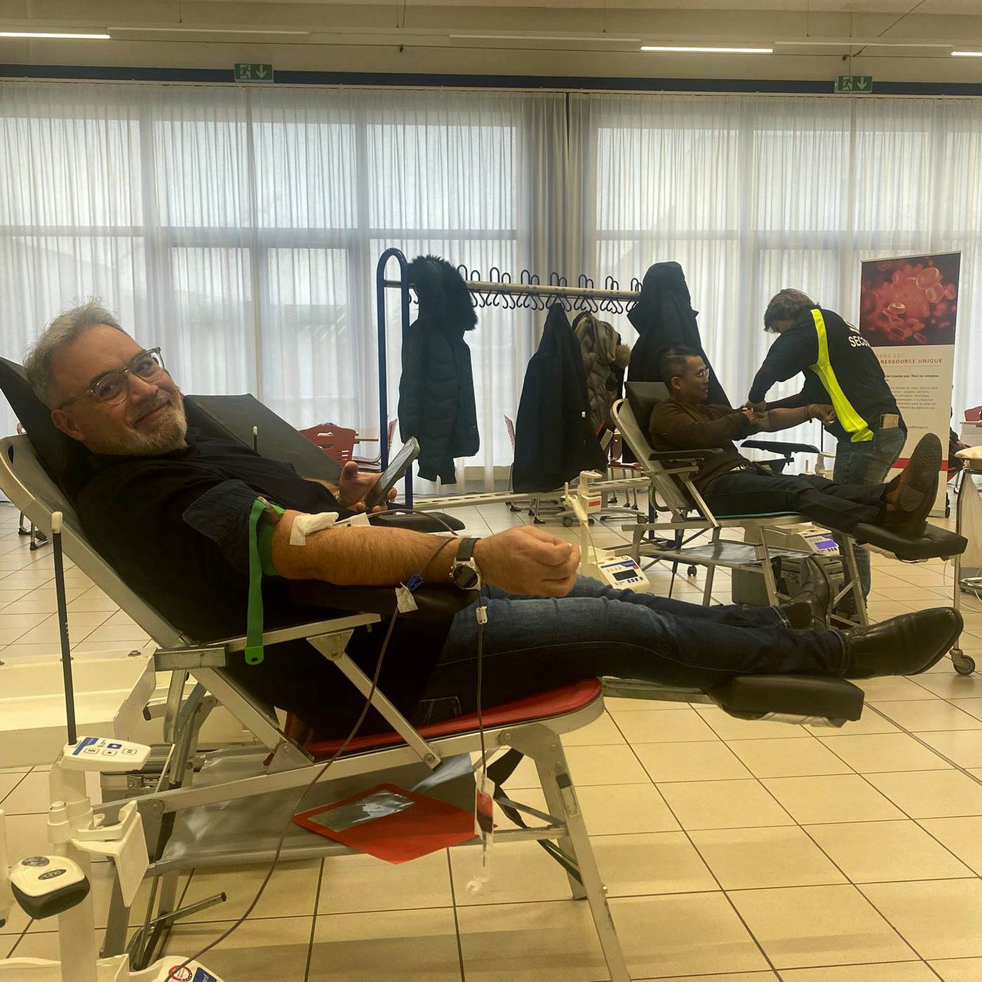A NIRU colleague giving blood during a group blood donation drive