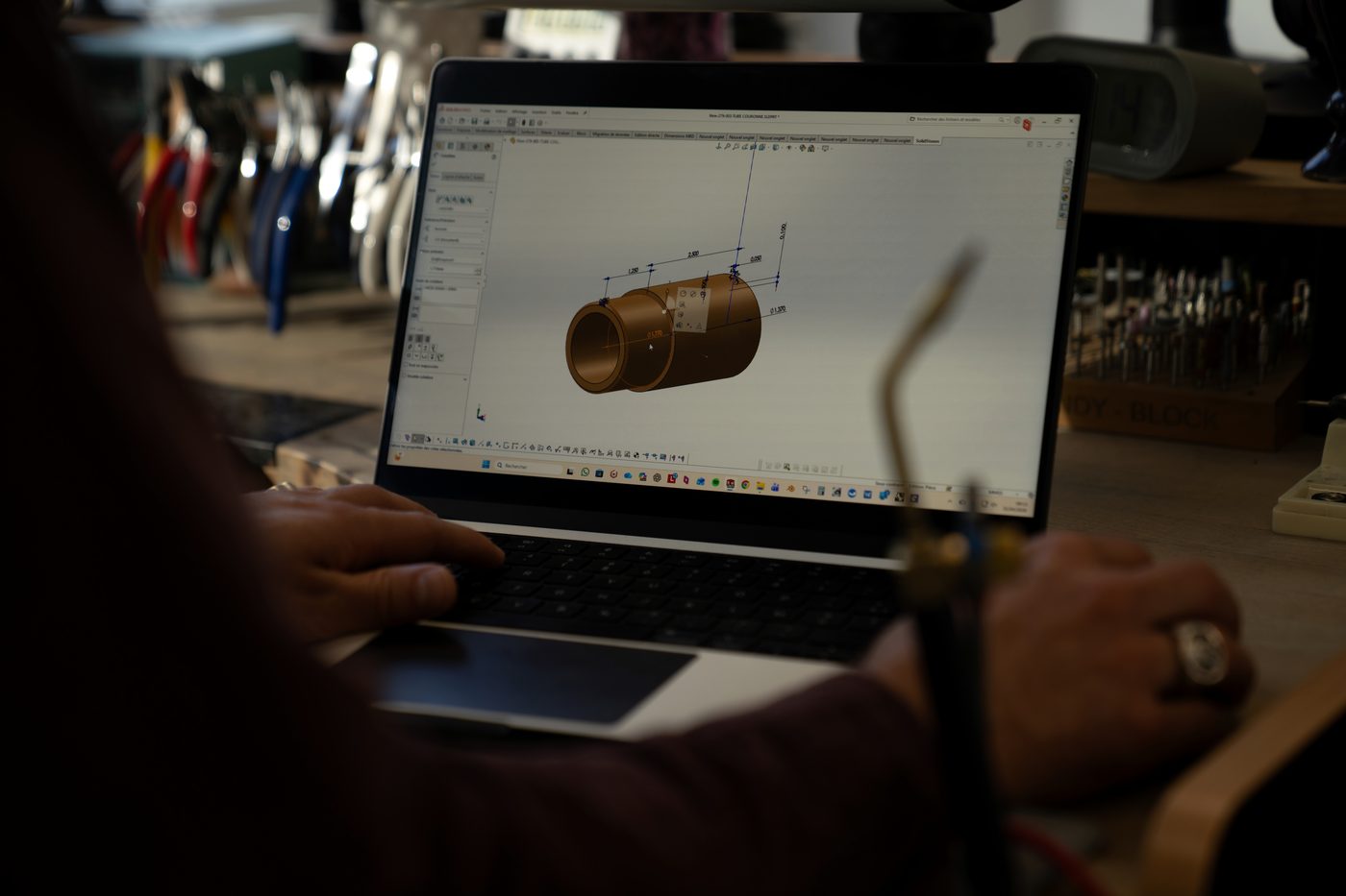 A three-dimensional model open on a laptop at the workstation.
