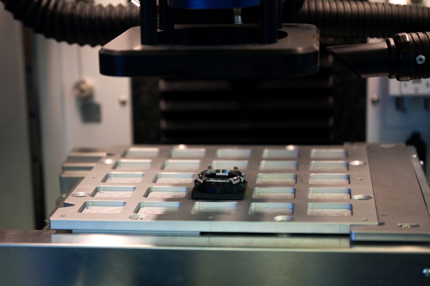 A case component located on the machine bed before marking.