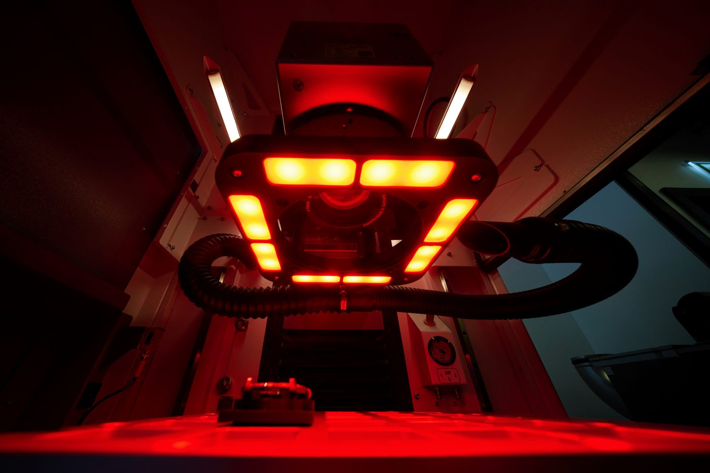 The illuminated head of the laser engraving machine.