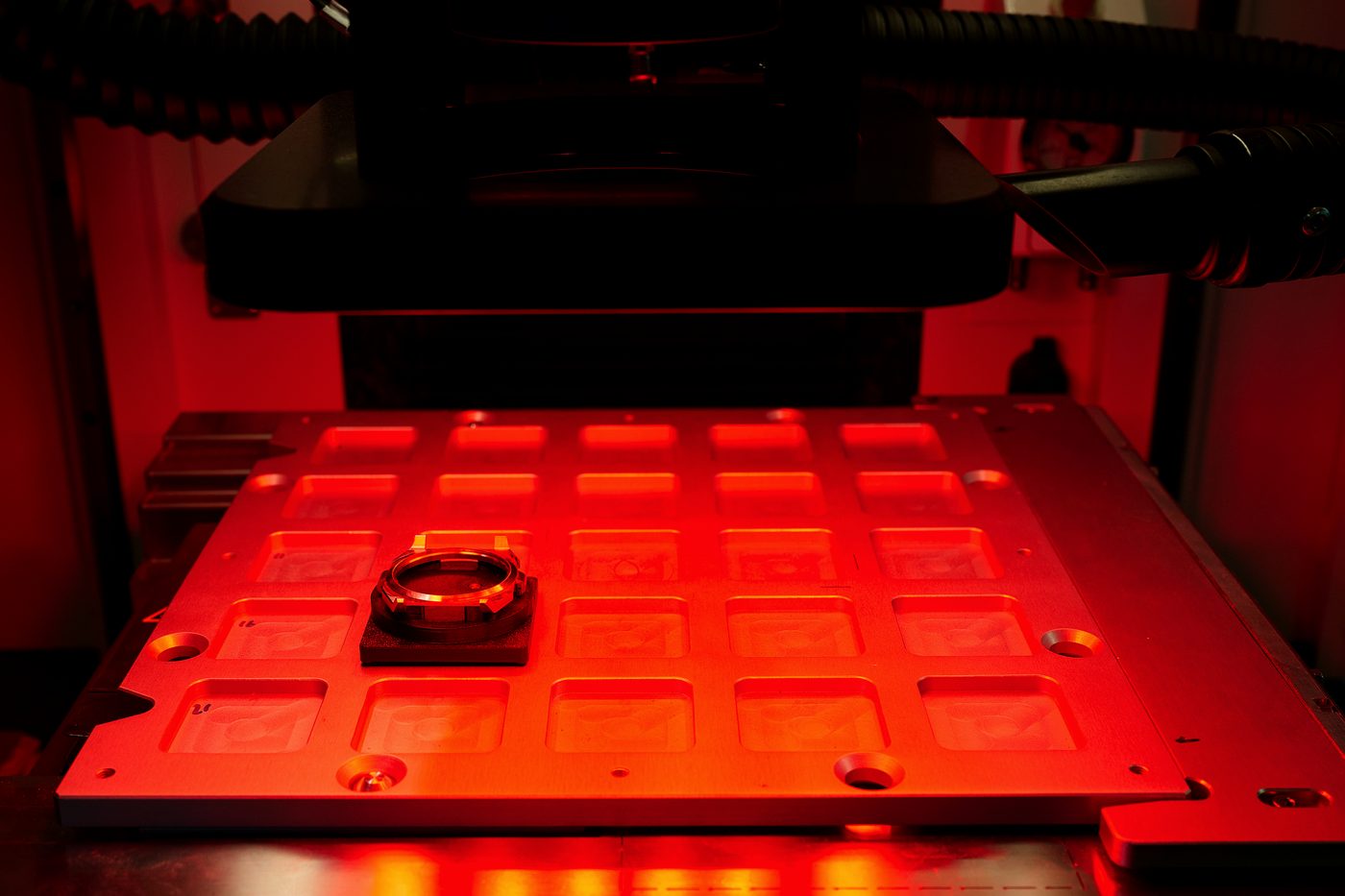 A watch component held in its seat under the laser.