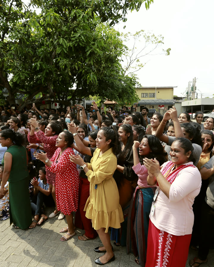 NIRU colleagues in Sri Lanka gathered outdoors, applauding together