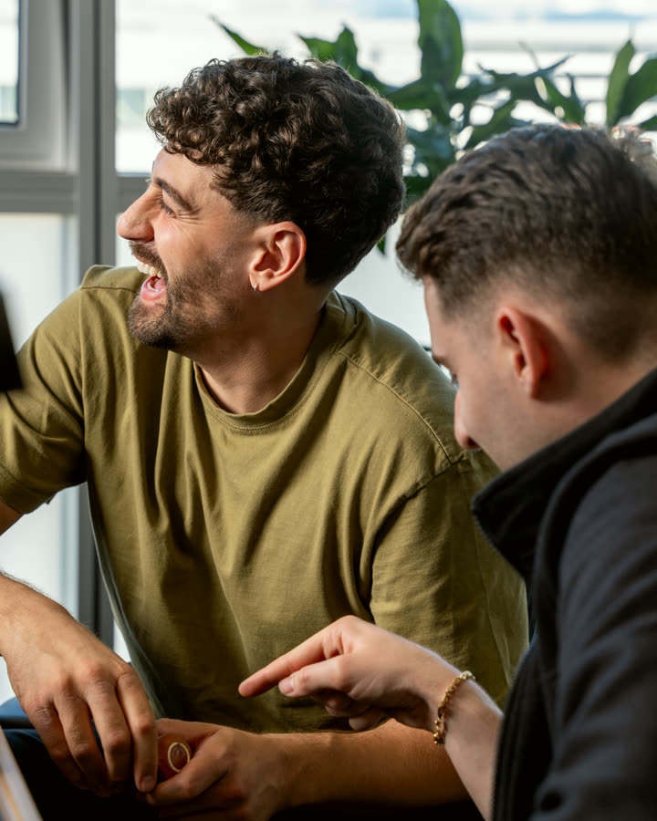 Two NIRU colleagues laughing together at the Geneva facility